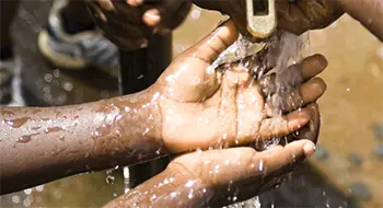 Hands under a clear stream of water