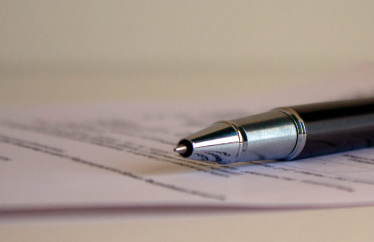 Document and pen on a white table