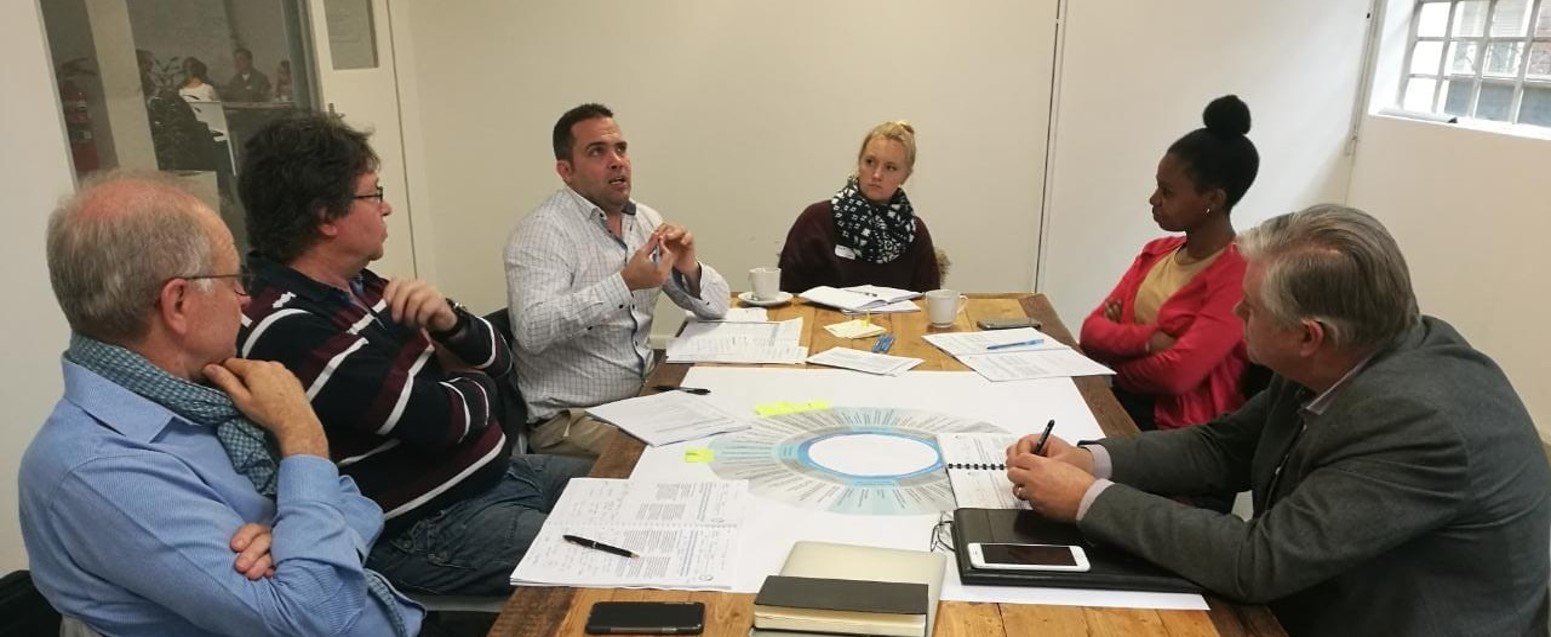 People gathered around a table for discussion