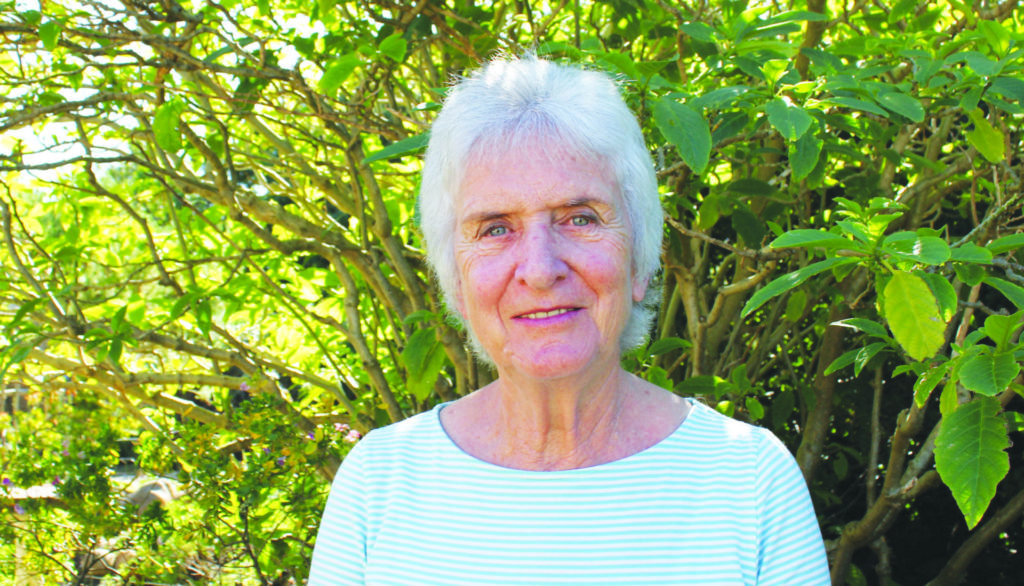 Dr Jackie King standing in front of a tree