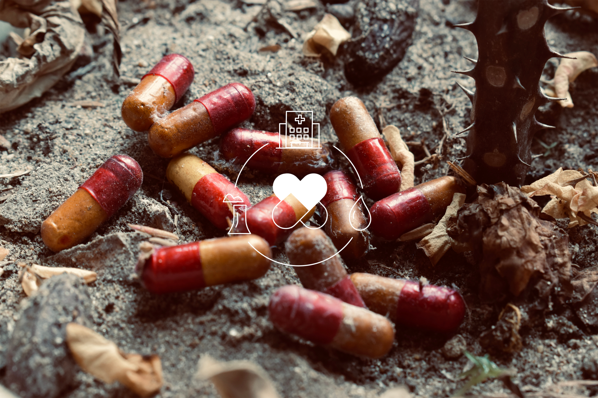Red and golden pills thrown over wet muddy ground, overlayed with a graphic of the interconnections 