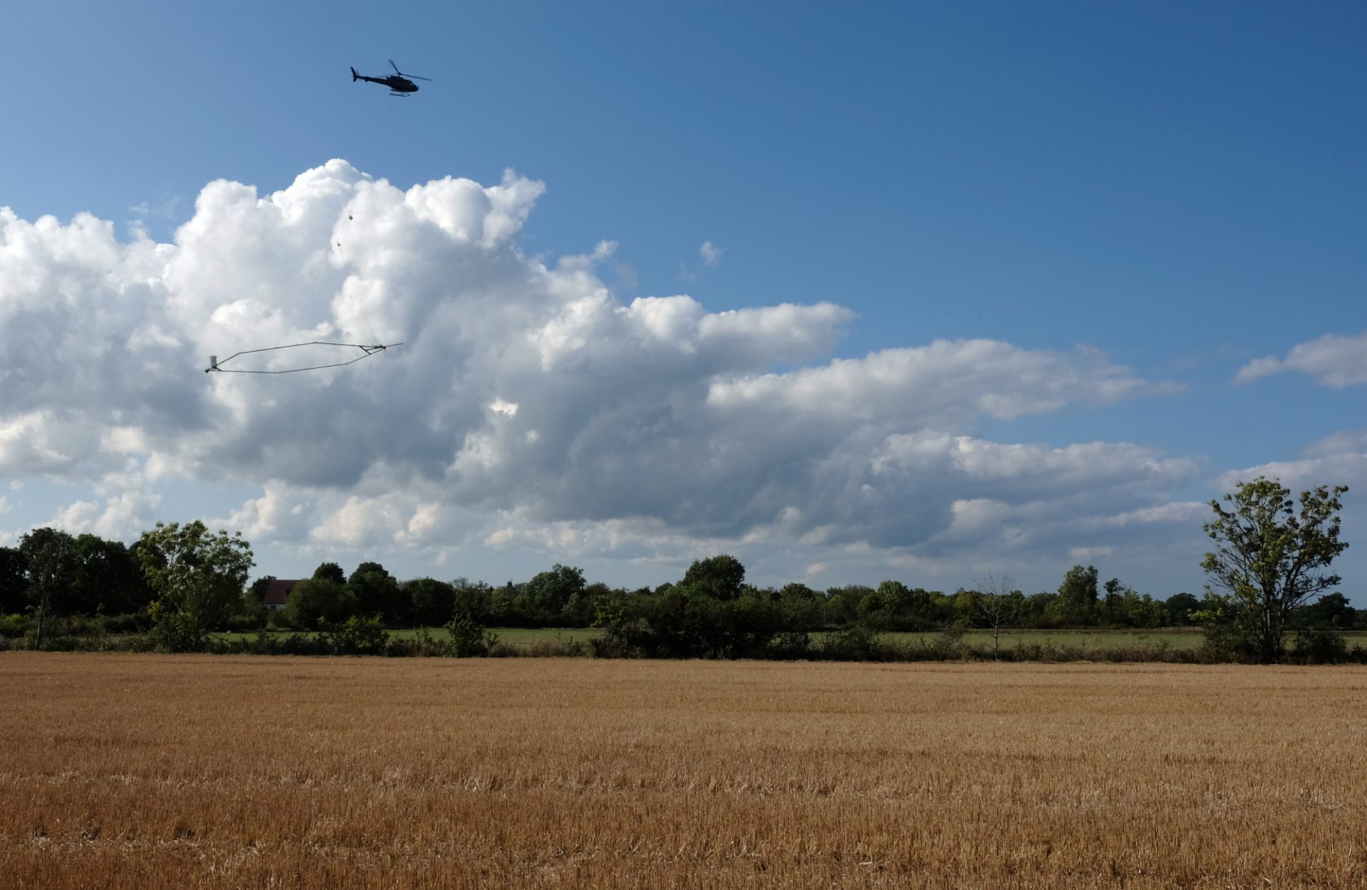 Helicopter hovering over a field