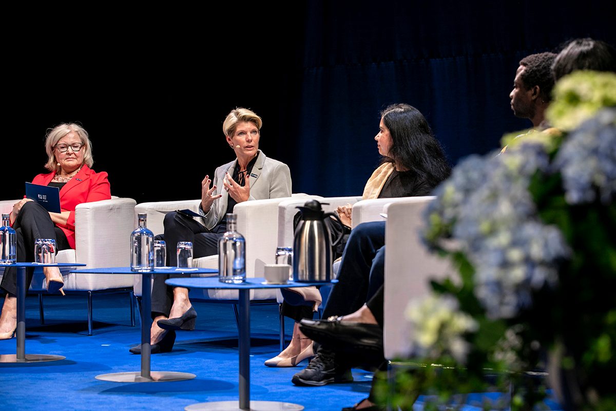 Karin Gardes sitting on Centre Stage at World Water Week 2023, speaking.
