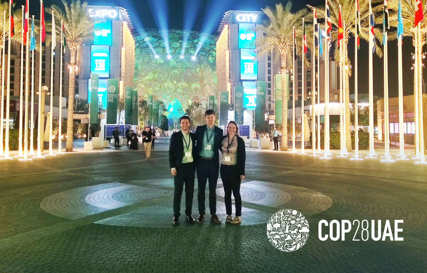 Ivan Sjögren, Manuel Eckert and Dani Gaillard-Picher standing in front of the Dubai City Expo at the closing of COP28, 2023