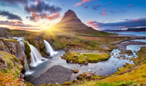 Colorful sunrise on Kirkjufellsfoss waterfall. Amazing morning scene near Kirkjufell volkano, Iceland.