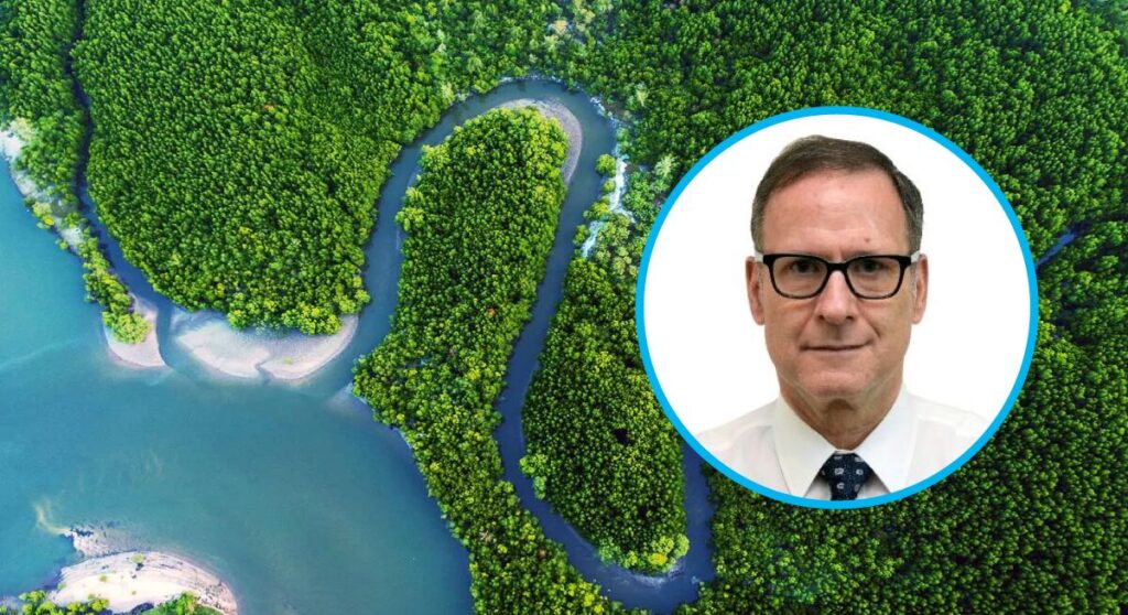 Portrait of Tom Panella over an aerial view of a river flowing into the forest and ending in a turquoise ocean