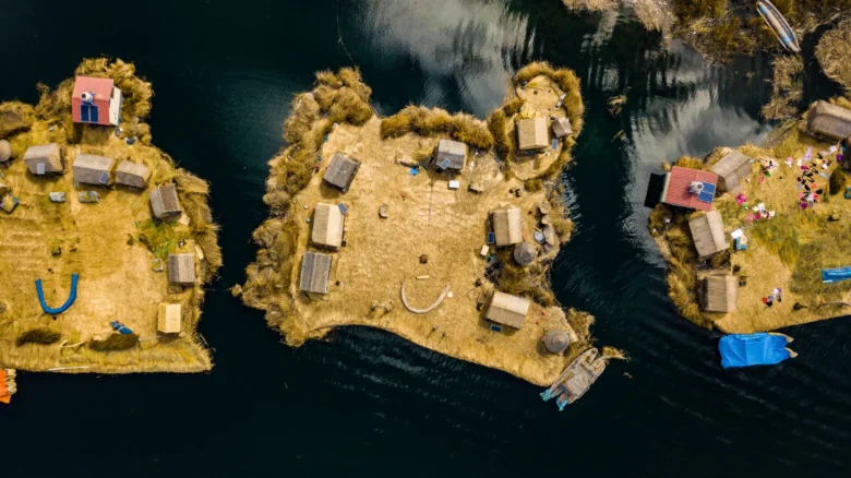 Aerial top view photo of floating islands on Lake Titicaca in Peru - a habitant of indigenous commun